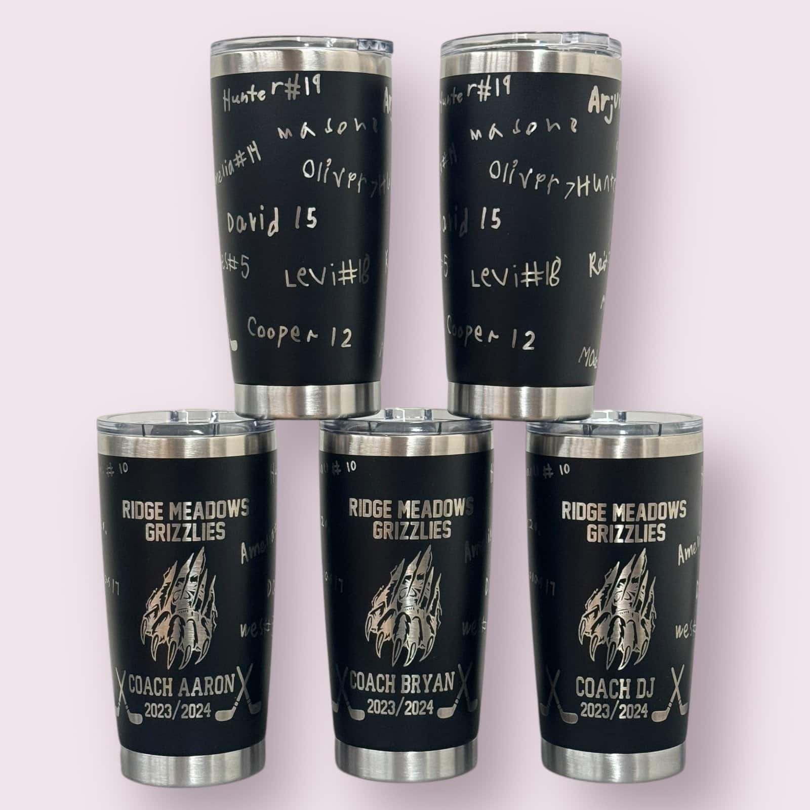 Custom hockey team tumblers with team logo, coach names, and player signatures.