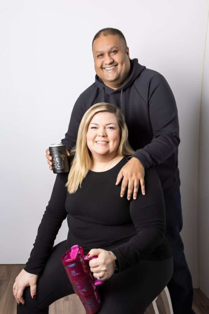 Happy couple holding personalized coffee mugs, celebrating friendship and creative crafts by Carly.